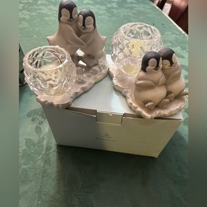A pair of Party Lite baby penguins with crystal glass candle holders